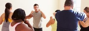 man teaching fitness class to other people